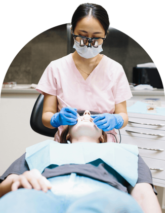 A dentist examining a patient in a dental chair at a Tooth Club clinic.